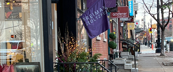 a city street with a flag hanging down