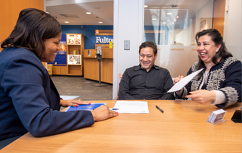 a teller helping customers