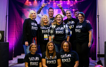 a group of employees in matching shirts